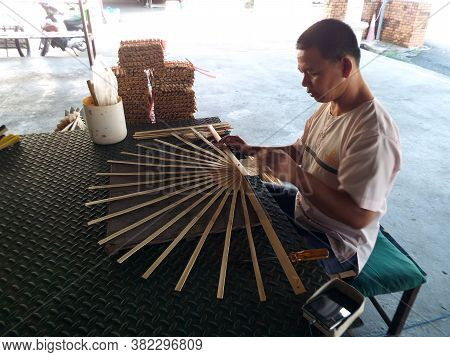 Bor Sang, Chiang Mai, Thailand, December 22, 2018: Craftsman Works On Bamboo Structure To Make A Fan
