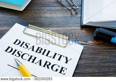 Disability Discharge Application Papers And Pen With Glasses.