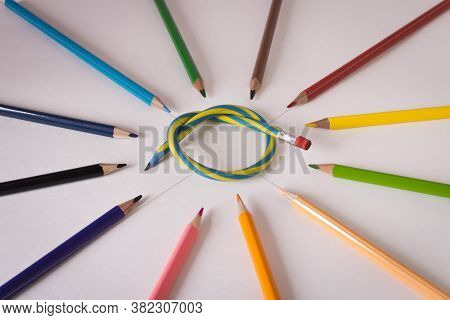 Flexible Pencil And A Set Of Colored Pencils On A Light Background. Selective Focus