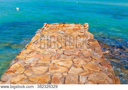 Rocky Pier And Turquoise Water In Costa Smeralda. Sardinia, Italy