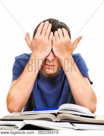 Tired Young Man Rub His Eyes On The School Desk Isolated On The White Background