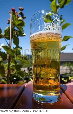 Feldkirch, Austria - July 26, 2020: A Glass Of Cold Beer On A Table In The Inn Garden