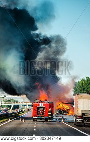 Accident And Fire On The Road Vertically, Truck In Fire With Black Smoke On The Road