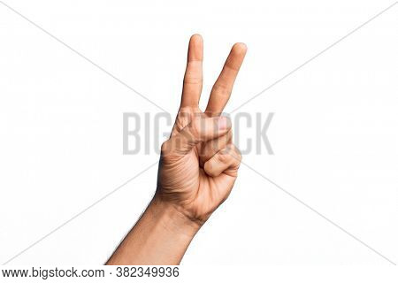 Hand of caucasian young man showing fingers over isolated white background counting number 2 showing two fingers, gesturing victory and winner symbol