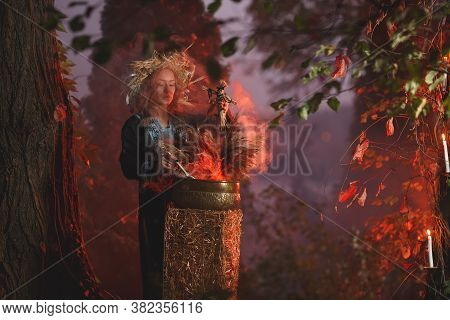 A Forest Witch Brews A Potion Holding A Voodoo Doll.