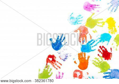 Colored Kids Handprints On White Background With Copy Space