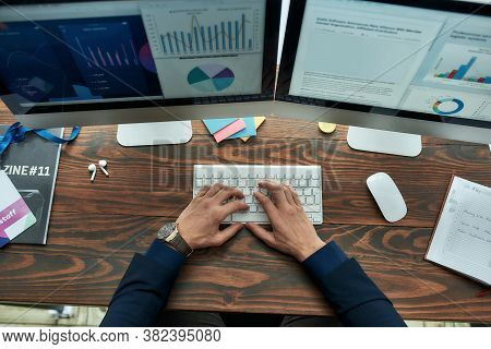 Top View Of A Businessman Or Financial Analyst Working On Computer, Analyzing Statistical Data, Grap