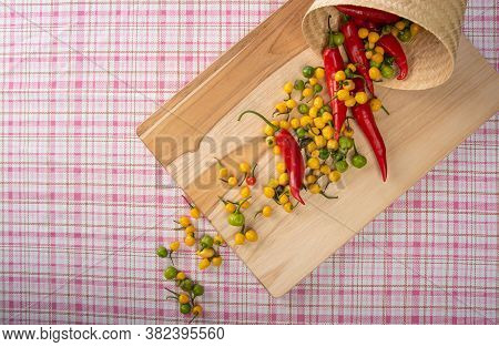 Colored Peppers Fallen From A Basket On A Table, Top View.