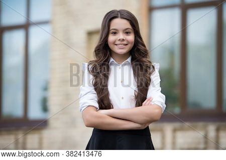 Dedicated To Learning. Confident Lyceum Student Keep Arms Crossed Outdoors. Happy Child Study In Lyc