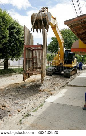 Eunapolis, Bahia / Brazil - November 17, 2010: Backhoe Machine Works On The Implementation Of A Sewa