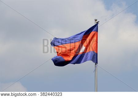 National Flag Of Cambodia On Bright Blue Sky Background. Blown Away By Wind. Cambodia Is One Of The 