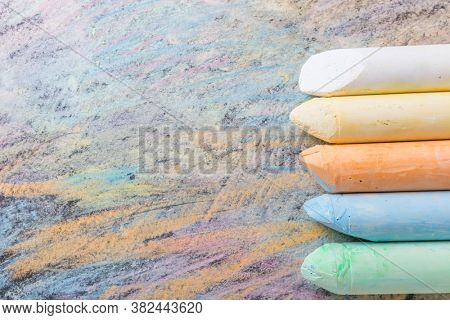 Crayons with colorful painted background. Back to school and art concept with copy space.