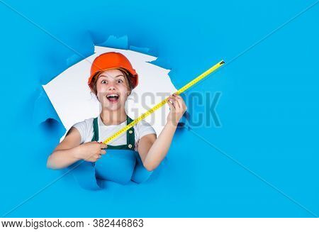 Little Girl Using A Measuring Tape. Construction Worker With Tape Measure. Cute Kid As A Constructio