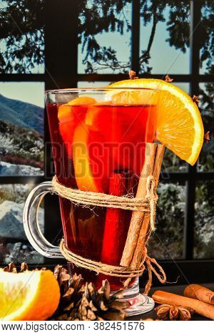 Mulled Wine Hot Christmas Drink With On A Windowsill, Next To The Window. Orange Slices, Cinnamon St