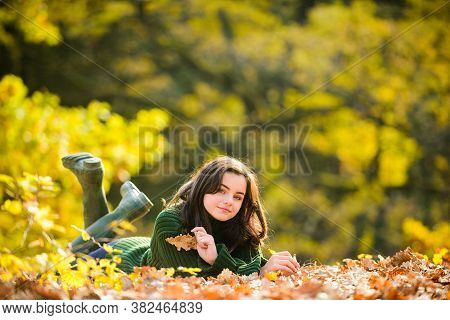 Smiling Teenage Girl Lying On Yellow Leaves In Autumn. Autumn Teenager On Leafs