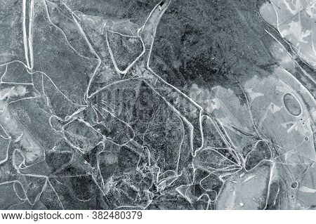 Frozen Puddle With Broken Ice. Winter Season.