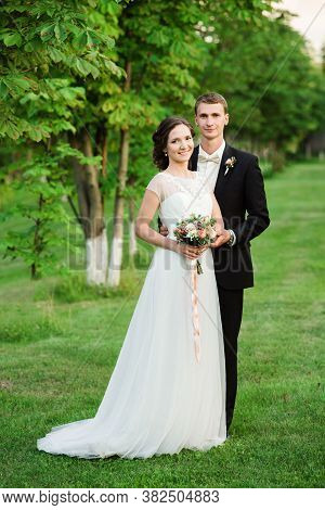Happy Young Couple Just Married - Wedding Day. Happy Couple Smilinging Happily On Their Wedding Day 