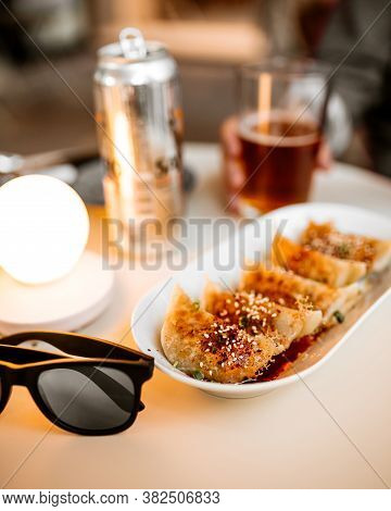 Gedza Dumplings On The Round Cafe Table With Glasses And Beer