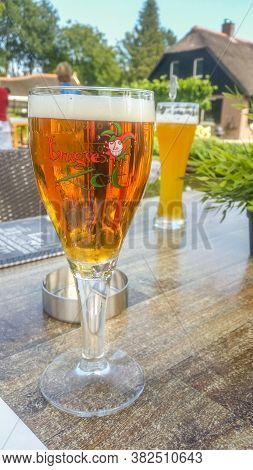 Giethoorn, Netherlands - 23 August, 2017: Fresh Belgium Beer Named Brugse Zot Served On A Glass. The