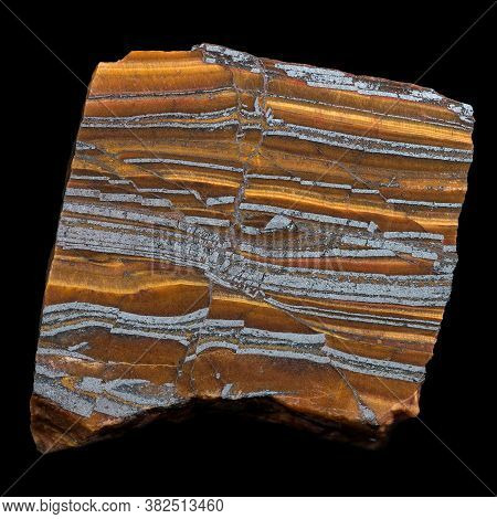 A Sample Of Striped Stratified Ferruginous Quartzite (jespilite) Rock Isolated On Black. Iron Ore An