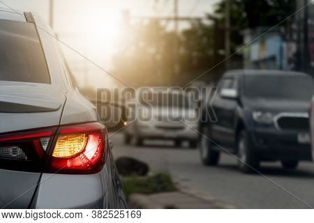 Turn Light Of Car On Asphalt Road.  Evening Road Traffic And Cars On The Opposite Lane Passing By.