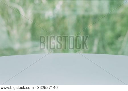 Empty Table In A Sun Drenched Summer Garden For Product Placement With Focus To The Table Top In The