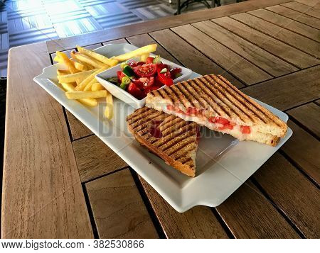 Turkish Fast Food Menu Toast With Salad And Potatoes / Club Sandwich Tost On Wooden Table.