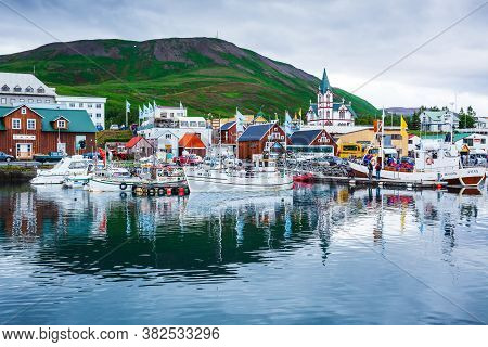 Husavik, Iceland - August 05, 2017: Husavik Harbour With Traditional Houses And Fisherman Boats.