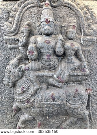 Lord Shiva And Parvati Sitting At The Top Of A Bull Sculpture. Bas Relief Sculpture Carved In The St