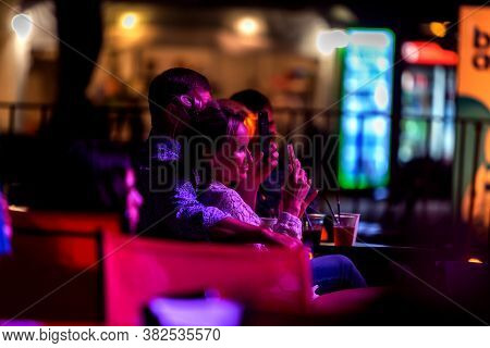 Odessa, Ukraine - Cirka 2020: Spectators At Concert In Theater Take Pictures Of Performance Of Their