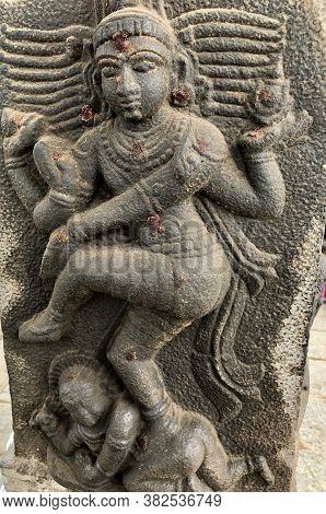 Sculpture Of A Hindu God With A Baby In  The Bottom Of The Feet. Bas Relief Sculpture Carved In The 