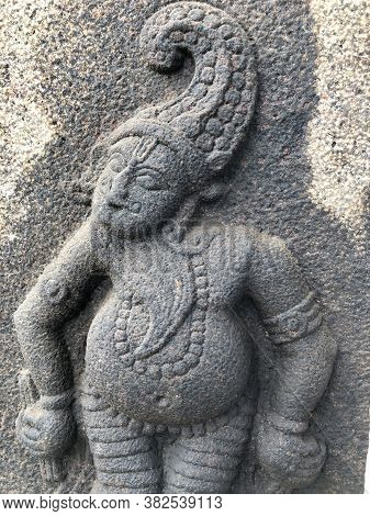 God With Animal Head Sculpture. Bas Relief Sculpture Of Hindu God Carved In The Stone Walls At Shiva