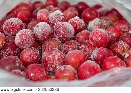Frozen Red Berries In A Plastic Bag. Frozen Red Cherries. Frost-covered Cherries. Red Cherry.
