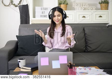 A Beautiful Young Woman Wearing Headset Is Making Video Conference Call