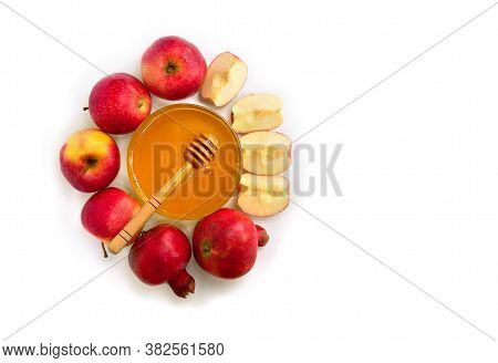 Honey In Glass Bowl, Wooden Honey Dipper, Red Apples, Garnet On A White Background With Space For Te