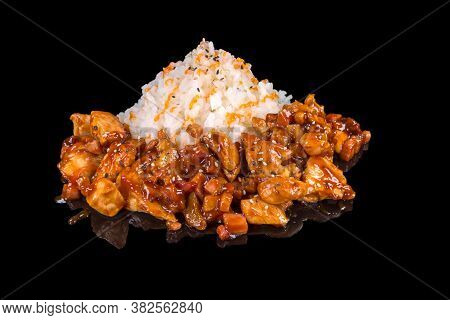 Delicious Cpicy Chicken Garniched With Rice, Isolated On Black Background, With Reflection