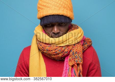 Funny African American Man In Yellow Scarf And Hat Freezing In Warm Clothing.
