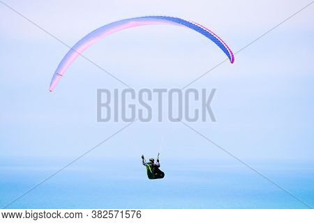August 25, 2020 In Lajolla, Ca:  Person Paragliding Over The California Coast With The Pacific Ocean