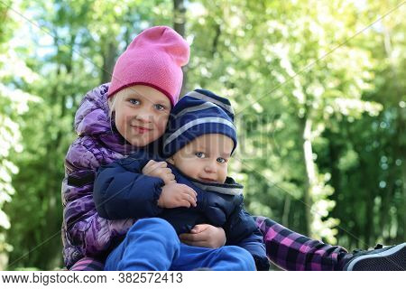 Two Cute Adorable Playful Caucasian Siblings Boy Girl Child Enjoy Havefun On Playground At Backyard 