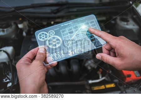 Car Engine Diagnostic Concept. Car Mechanic Holding In Hands A Digital Frameless Computer With Chart
