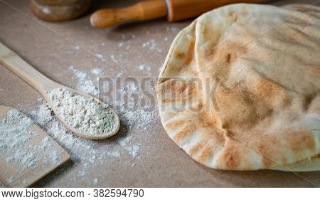 Kuboos Or Khubz - Arabic Bread On A Brown Table In The Kitchen Kitchen