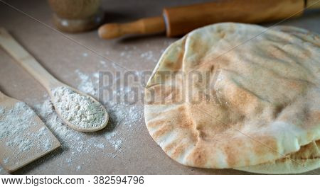 Kuboos Or Khubz - Arabic Bread On A Brown Table In The Kitchen Kitchen