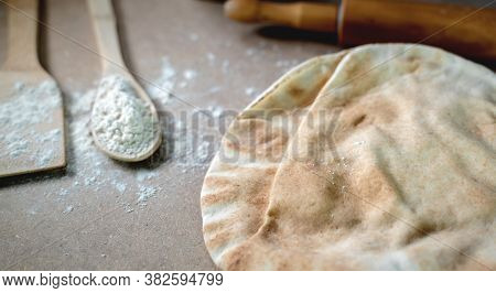 Kuboos Or Khubz - Arabic Bread On A Brown Table In The Kitchen Kitchen