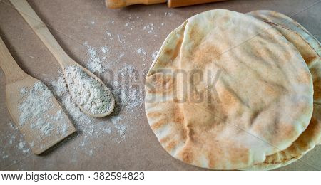 Kuboos Or Khubz - Arabic Bread On A Brown Table In The Kitchen Kitchen