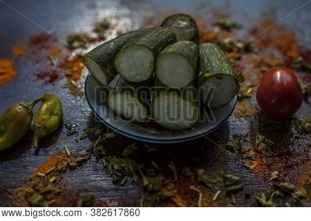Close Up Shot Of Raw Galka Or Sponge Gourd Cut In A Glass Plate Along With All The Spices Including 