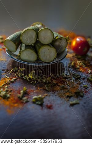 Close Up Shot Of Raw Galka Or Sponge Gourd Cut In A Glass Plate Along With All The Spices Including 