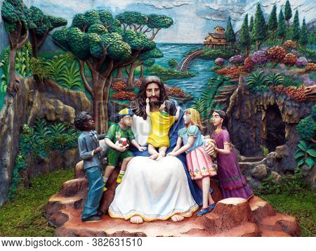 Medan, Sumatra, Indonesia, January 9, 2018: Sculpture Of Jesus Surrounded By Children In Graha Maria
