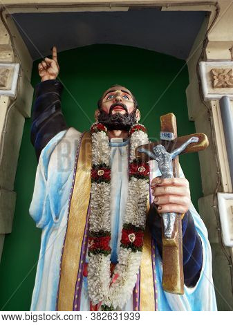 Medan, Sumatra, Indonesia, January 9, 2018: Image Of A Saint Pointing To The Sky With A Crucifix In 