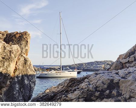 Sailboat Mooring In A Small Cove Of Beach Velo Zarace On Hvar Island, Croatia In Sunset