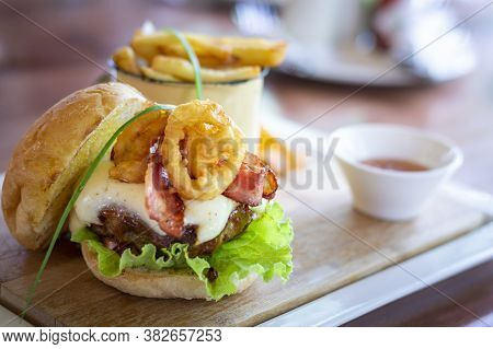 Tasty Beef Hamburger, With Calamares, Salad, Bacon And Egg And French Fries. Selective Focus.
